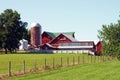 Bright Red Farmhouse and Silo in the Midwest Royalty Free Stock Photo