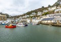 Bright Red Fishing Boat moord in Polperro Harbour, Cornwall, UK Royalty Free Stock Photo