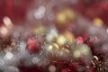 Bright red and gold balls on blurred sparkling background, bokeh lights. Golden new year 2021. Merry Christmas card Royalty Free Stock Photo