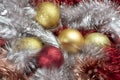 Bright red and gold balls on blurred sparkling background, bokeh lights. Golden new year 2021. Merry Christmas card Royalty Free Stock Photo