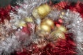 Bright red and gold balls on blurred sparkling background, bokeh lights. Golden new year 2021. Merry Christmas card Royalty Free Stock Photo