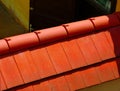 red half round ridge clay roof tiles and flat sloped tiles over entrance gate. Royalty Free Stock Photo