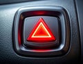 Bright red hazard warning light button with concentric triangles on car dashboard image Royalty Free Stock Photo