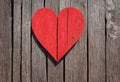 Bright red heart as a symbol of love and friendship on the wooden background