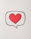 A bright red heart placed inside a hand drawn speech bubble Royalty Free Stock Photo