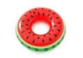 A bright red inflatable pool ring with a watermelon design on a white background Royalty Free Stock Photo