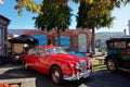 A bright red Jaguar at a vintage car show in Motueka High Street in front of the museum