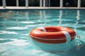 A bright red lifebuoy floats on the tranquil surface of the pool