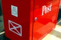 old style shiny red metal mail collection box at post office with white symbols. Royalty Free Stock Photo