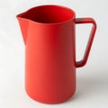 Vibrant red pitcher with a sturdy handle for serving drinks white background Royalty Free Stock Photo