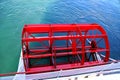 A bright red paddle wheel from a boat on a lake Royalty Free Stock Photo