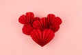 Bright red paper heart of many hearts of asian ribbed fans on pastel pink background, top view, copy space. Valentine day, wedding Royalty Free Stock Photo