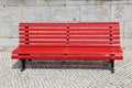 Bright red park bench