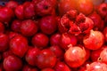 Bright red pomegranates in sunlight, close-up. Lots of pomegranates, background image. Pomegranate fruit on the counter in local