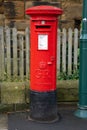 Bright red postbox of the Royal Mail in England Royalty Free Stock Photo