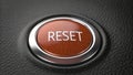 Bright red reset button on a textured black surface ready for action in a control or electronic device setup Royalty Free Stock Photo