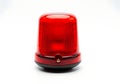 Bright red rotating beacon light on white background Royalty Free Stock Photo