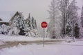 Red Stop Sign with Snow on Streets Royalty Free Stock Photo