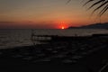 Bright red sunset on the background of the sea and the beach in Alanya, Turkey Royalty Free Stock Photo