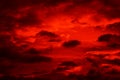 Bright red sunset. Dramatic evening sky with clouds. Fiery skies with space for design. Magic fantasy sky.