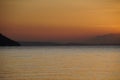 Bright red sunset over the Aegean Sea. The sun went down behind the mountains. Royalty Free Stock Photo