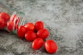 Tomato, bright red, in a transparent bottle, horizontally, with a drop of water Royalty Free Stock Photo