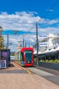 Bright red tramway on streets of Glenelg toan, South Australia