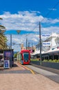 Bright red tramway on streets of Glenelg town, South Australia
