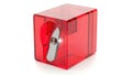 Bright red transparent plastic pencil sharpener with a silver blade on a white background Royalty Free Stock Photo