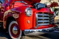 Bright red vintage retro truck with an open hood standing at an exhibition on a street of a provincial town Royalty Free Stock Photo