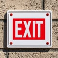 Red Exit Sign on an Exterior Brick Wall Royalty Free Stock Photo