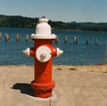 Bright red and white fire hydrant along the bay Royalty Free Stock Photo