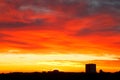 Bright red, yellow, blue clouds in sunrise sky Royalty Free Stock Photo
