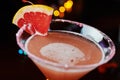 Bright refreshing cocktails on a table in a restaurant with creative decoration of red orange slices on a wooden table in a bar or Royalty Free Stock Photo