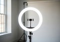 Illuminated ring light with smartphone mount setup for content creation and photography white background Royalty Free Stock Photo