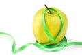 Bright ripe yellow apple and green ribbon Royalty Free Stock Photo