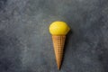 Bright Ripe Yellow Lemon in Waffle Ice Cream Cone on Dark Concrete Stone Background. Summer Fruits Dessert Freshness Vitamins