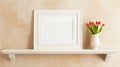 In a bright room, a white shelf holds a white frame with spring flowers in a vase, set against a beige wall Royalty Free Stock Photo