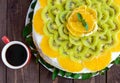 Bright round festive fruit cake decorated with kiwi, orange, mint Royalty Free Stock Photo