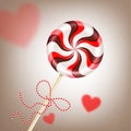 Bright round striped red brown lollipop with decorative cord. and blurred hearts. Berry and chocolate candy on a stick. Realistic