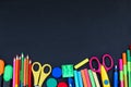 Bright school supplies on blackboard background ready for your design Royalty Free Stock Photo