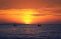 bright sea landscape with red sunset ,blue the sea and the silhouette of the fishing boats Royalty Free Stock Photo