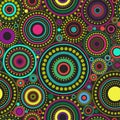 Bright seamless abstract pattern of colorful circles and dots on black background. Kaleidoscope backdrop.