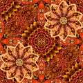 Bright seamless pattern in warm tones. Mandala flower in patchwork style on ornamental background. Mexican, indian motives