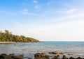 Bright seascape background on sunny day. Summer background with beach rocks, island, clear sea water. Royalty Free Stock Photo