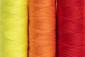 Bright sewing thread spools close up, full frame background, top view. Royalty Free Stock Photo
