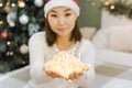 Shining lights in hands of young asian woman with santa hat, magic decoration at New Year or Christmas Royalty Free Stock Photo