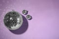 Bright shiny disco balls on violet background, flat lay. Space for text Royalty Free Stock Photo