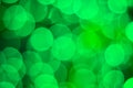 Bright shiny green bokeh lights background for celebration greet