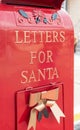 Bright shiny red mailbox for children to mail letters to Santa Claus Royalty Free Stock Photo